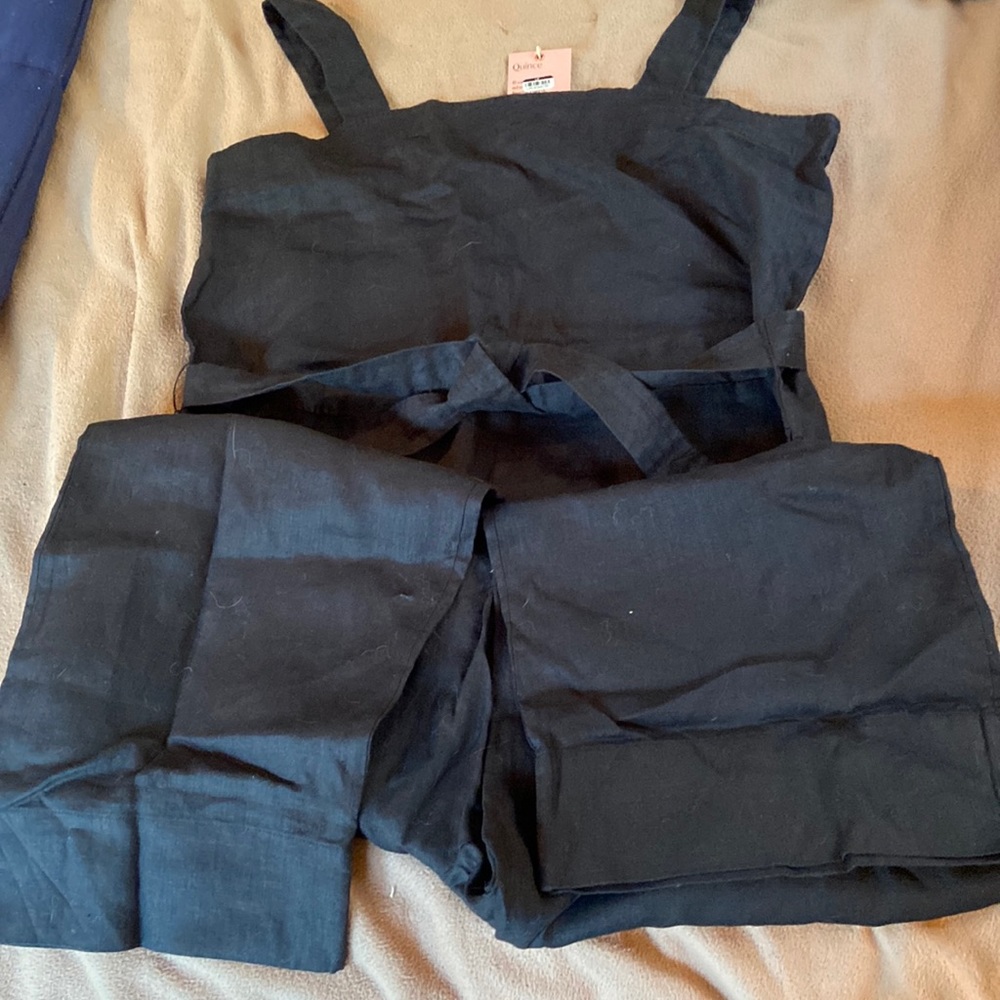 NWT black jumpsuit in 100% linen with front pockets and rear. Waist tie